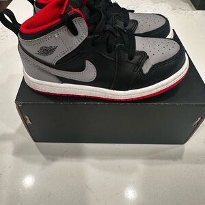 Kids Jordan Black and Gray Sneakers with Red Soles
